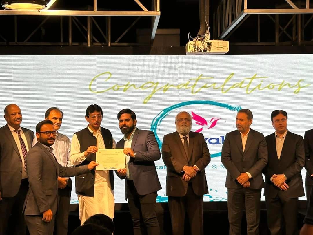 Koyal certificate presentation with the team on stage